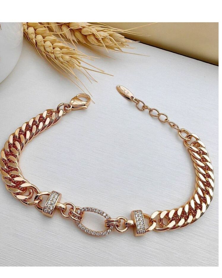 دستبندزنانه طلایی طرح کارتیه با قفل بیضی با نگین های سواروسکی برند ژوپینگ در نوروژ اکسسوری